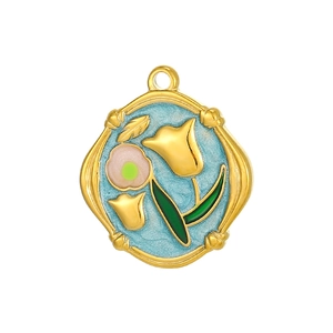 Detail of vintage irregular gold tulip pendant with blue enamel and pink flower accent