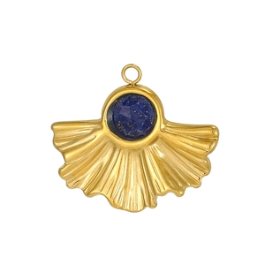 Detailed close-up of a gold fan-shaped pendant with a faceted deep blue gemstone inlay