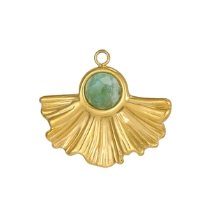 Detailed fan-shaped gold pendant with green gemstone and ridged metal texture