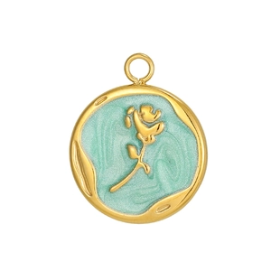 Detail of round gold stainless steel pendant with embossed rose and mint green enamel