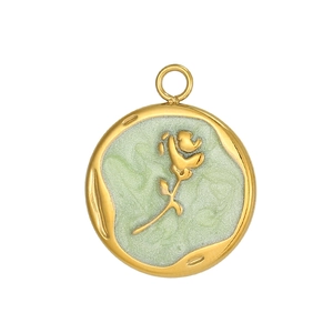 Macro view of gold stainless steel pendant featuring green enamel and rose relief detail