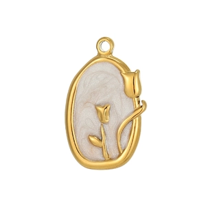 Detail of a gold tulip pendant featuring embossed floral design and white enamel inlay