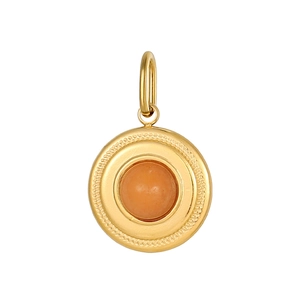 Close-up of golden vintage round pendant with orange gemstone and textured metal edges
