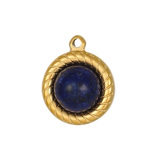 Detail of vintage round gold twisted pendant with inlaid blue stone and textured finish
