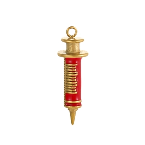 Macro shot of gold syringe pendant with red enamel detailing and engraved scale markings