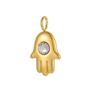 Macro shot of gold Hamsa Hand pendant with zircon inlay and stainless steel texture