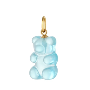 Detail of light blue gummy bear pendant with golden ring on white background