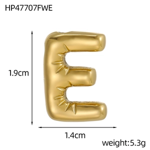 Macro view of golden puffy letter E pendant with sunburst texture details and dimensions