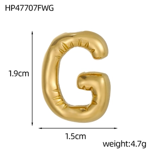 Detail of 14k gold balloon-style letter G pendant with polished wrinkled finish