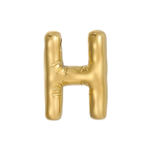 Macro detail of golden bubble letter H pendant with unique bamboo texture finish