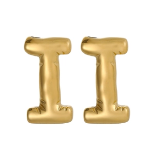 Close-up of golden letter I earrings with 3D bubble balloon effect and polished finish