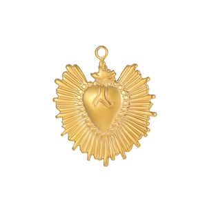 Detailed close-up of golden stainless steel sacred heart charm with radial sunburst lines