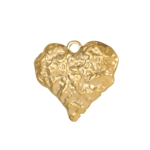 Detail of a hammered heart pendant in gold finish with textured metal surface