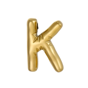 Macro shot of 14k gold plated 3D bubble letter K pendant with starburst engraving details
