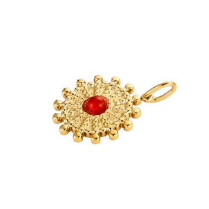 Close-up of vintage sunburst stainless steel pendant with a central red stone inlay