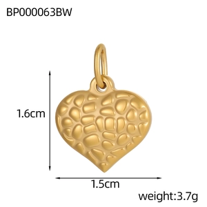 Macro shot of gold heart pendant with pebble texture and size markings of 1.6cm