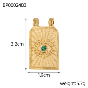 Detail of gold evil eye pendant with green stone, rectangular shape 3.2cm by 1.9cm