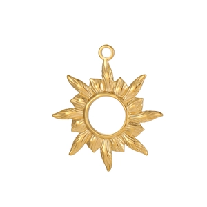 Detail of a golden sunburst pendant with radial texture and polished metal finish