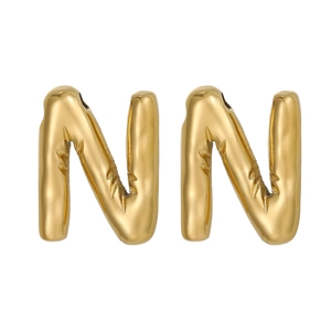 Macro detail of polished gold-plated letter N pendants for DIY necklace jewelry making