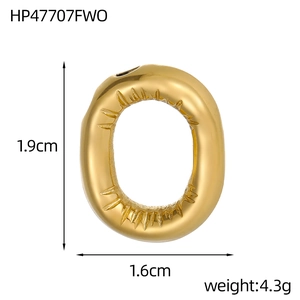 Macro shot showing dimensions and radial texture of golden 14k bubble letter pendant