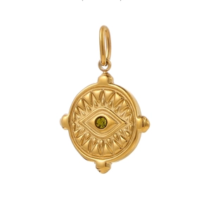 Macro detail of gold evil eye coin pendant with green zircon inlay and sunburst texture