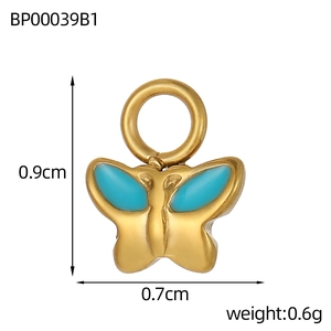 Macro shot of gold butterfly pendant with sky blue enamel and closed jump ring