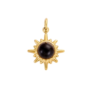 Detailed view of vintage gold sunburst pendant with black stone inlay and polished bail