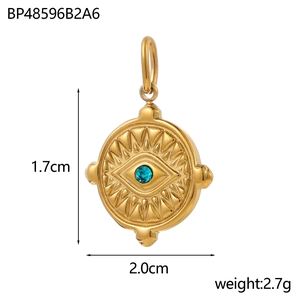 Detail view of gold evil eye pendant with blue crystal and sunburst relief texture