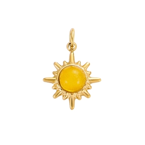 Detail of vintage sunburst pendant in gold finish with a yellow stone centerpiece