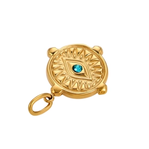 Macro shot of vintage gold evil eye pendant with blue zircon stone and sunburst pattern