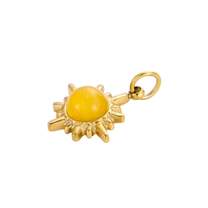 Detailed shot of a vintage gold sunburst pendant set with a translucent amber stone