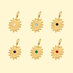 Macro display of six vintage gold evil eye pendants with various natural stone inlays