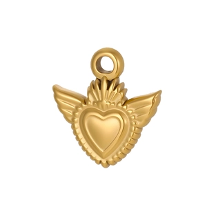 Detailed view of a golden vintage baroque style winged sacred heart jewelry pendant