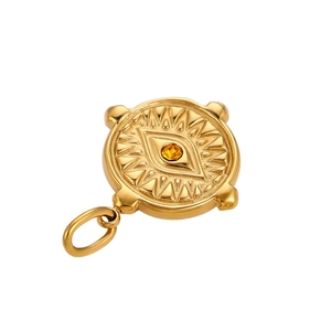Macro detail of golden evil eye pendant with sunburst texture and yellow zircon inlay