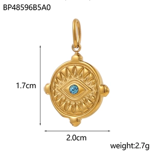 Detail view of a vintage gold evil eye pendant with blue zircon and radial texture details