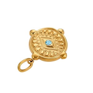 Macro shot of gold Evil Eye coin charm with blue zircon and sunburst detailing