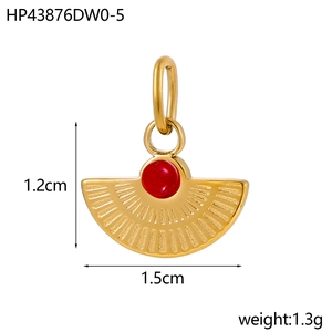 Macro view of a 1.2cm vintage gold fan-shaped pendant with red stone inlay