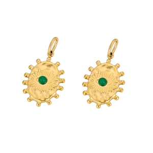 Detailed macro view of gold plated evil eye pendant with sunburst texture and green gemstone