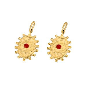 Close-up of golden fan-shaped pendants with hammered metal texture and red stone inlay