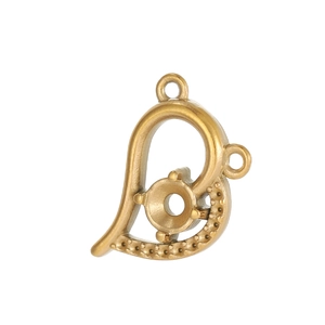 Detailed view of a vintage gold heart-shaped pendant base with dual hanging loops