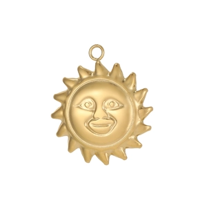 Macro detail of golden sun face pendant with raised features and radiant solar rays
