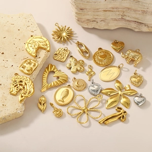 Mixed set of golden stainless steel geometric pendants featuring animal and floral shapes