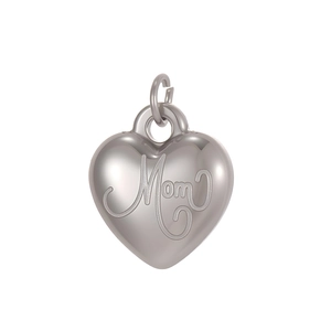 Macro detail of a silver heart-shaped pendant with Mom engraving and a ring for necklaces