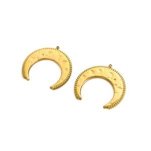 Detailed macro view of hammered vintage sun-moon moon charms in golden stainless steel