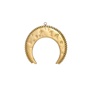 Macro detail of golden crescent moon pendant with hammered texture and beaded edges