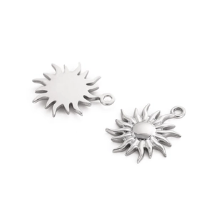 Detailed macro view of silver sun pendants showing both textured front and smooth back sides