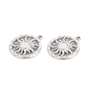Detailed close-up of sun-shaped stainless steel charms with polished finish and dot border