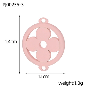 Macro detail of pink clover charm with dual hooks, measuring 1.4cm by 1.1cm for DIY jewelry