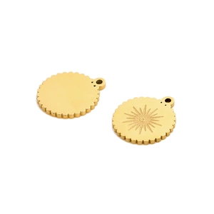 Close-up of golden sun pattern pendants with scalloped edges for DIY jewelry making
