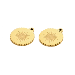 Detailed view of round gold celestial charms with sunburst relief and scalloped edges